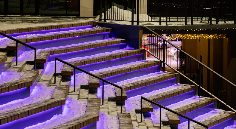 Massive corporate jubilee stage setup featuring custom projection mapping and kinetic lighting.